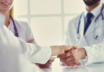 Wall Mural - Doctor shaking hands with a male patient in the office