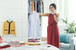 © StockPhotoPro - Woman choosing clothes in her bedroom