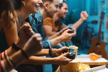 Cheerful friends playing video games together