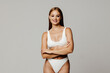 © F8  \ Suport Ukraine - Young pretty woman with perfect slim body. Beautiful model wearing inner wear, smiling and posing on grey background. Concept of beauty, body and skin care, health, plastic surgery, cosmetics, ad