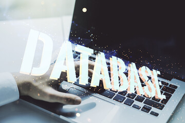 Poster - Double exposure of creative Database word hologram and hands typing on laptop on background, research and development concept