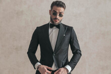 Elegant Businessman In Black Tuxedo Wearing Sunglasses And Posing