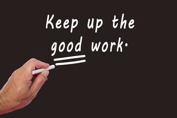 Wall Mural - Male hand writes in white chalk pencil the word KEEP UP THE GOOD WORK.