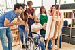 © Krakenimages.com - Group of young paint students smiling happy and looking draw of disabled partner sitting on wheelchair at art studio.