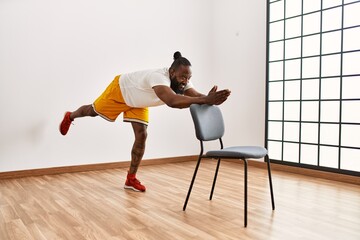 Wall Mural - Young african american man smiling confident training at sport center