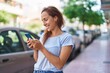 © Krakenimages.com - Young woman smiling confident using smartphone at street