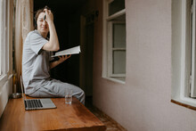 Woman Sitting On The Table At Home With Notebook And Laptop In Headphones