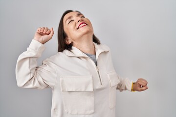 Sticker - Middle age hispanic woman standing over isolated background stretching back, tired and relaxed, sleepy and yawning for early morning