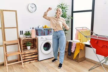 Poster - Young caucasian woman smiling confident dancing at laundry room