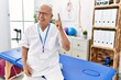 © Krakenimages.com - Senior physiotherapy man working at pain recovery clinic pointing finger up with successful idea. exited and happy. number one.