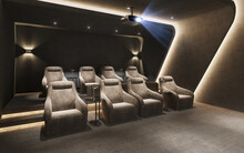 3d Render Of A Chic Home Cinema Room With Hidden Lights And Velvet Armchairs With Table Lamps And A Big Movie Screen	
