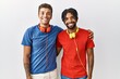 © Krakenimages.com - Young hispanic brothers standing over isolated background wearing headphones with a happy and cool smile on face. lucky person.
