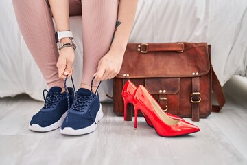 Sticker - Chinese woman tying shoes sitting on bed at bedroom