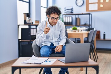 Sticker - Hispanic man doing video call waving to laptop smiling with an idea or question pointing finger with happy face, number one