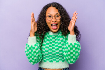 Wall Mural - Young hispanic woman isolated on purple background laughs out loudly keeping hand on chest.