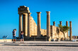 Visitors making a photo of  temple of Athena Lindia in Lindos acropolis in Rhodes island in Greece
