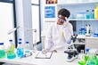 © Krakenimages.com - African american woman wearing scientist uniform stressed working at laboratory