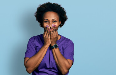 Canvas Print - African american woman with afro hair wearing casual purple t shirt laughing and embarrassed giggle covering mouth with hands, gossip and scandal concept