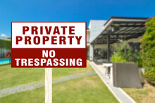 A Sign Warning Private Property And No Trespassing In Front Of A Luxury Home. A Cautionary Signage.
