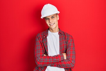 Poster - Young hispanic man wearing architect hardhat happy face smiling with crossed arms looking at the camera. positive person.