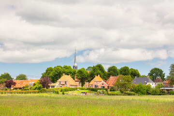 Wall Mural - Summer view of the Dutch small terp village Niehove in the province of Groningen, The Netherlands