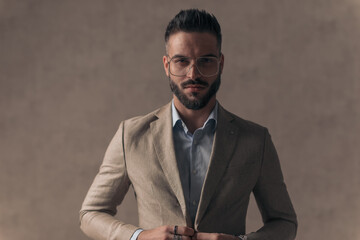 Poster - portrait of handsome businessman unbuttoning and opening suit