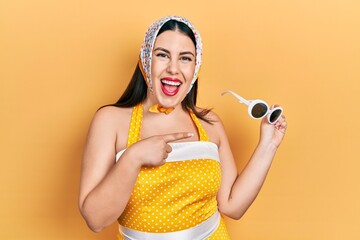 Canvas Print - Young hispanic woman wearing pin up style smiling happy pointing with hand and finger