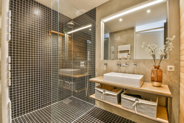 Sinks with mirrors and shower box with glass door in modern bathroom with white tiled walls