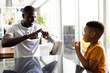 © Wavebreak Media - Image of african american father and son using sing language