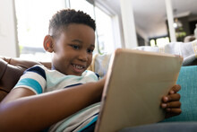 Image Of Smiling African American Boy Using Tablet