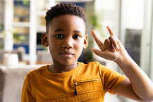 Image Of Smiling African American Boy Using Sign Language