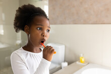 Image Of African American Girl Brushing Teeth