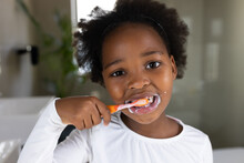 Image Of African American Girl Brushing Teeth