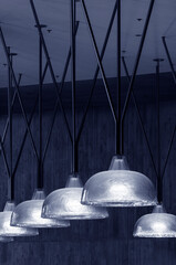 Poster - Row of pendant light lamps set in modern interior