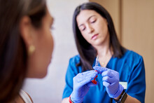 Esthetician With Syringe Before Making Collagen Injection