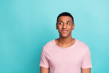 Wall Mural - Photo of positive dreamy young man dressed pink t-shirt looking empty space isolated turquoise color background