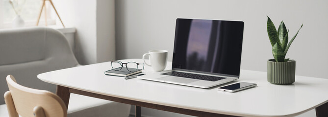 workplace, laptop computer with coffee cup, mobile phone and glasses panoramic banner. home office, 