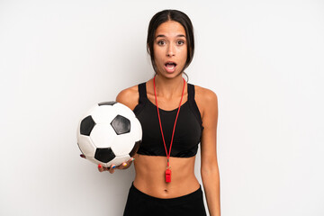 Wall Mural - hispanic pretty woman looking very shocked or surprised. soccer and fitness concept