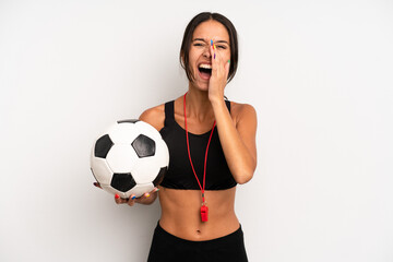 Wall Mural - hispanic pretty woman feeling happy,giving a big shout out with hands next to mouth. soccer and fitness concept