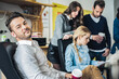 © ADDICTIVE STOCK - Man sitting near colleagues in office
