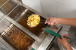 © ADDICTIVE STOCK - Unrecognizable chef frying potatoes in kitchen