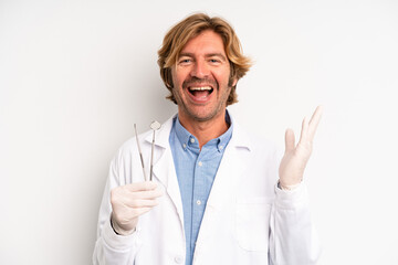 blond adult man feeling happy, surprised realizing a solution or idea. dentist concept