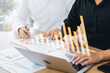 © Thapana_Studio - Business team using laptop computers analyze business growth and investment, strategic planning to increase sales profits, long-term business plan.