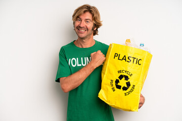 blond adult man feeling happy and facing a challenge or celebrating. ecology concept