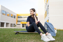 Girl Browsing Smartphone Near School