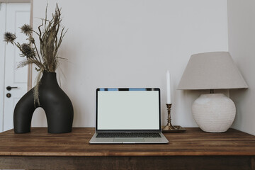 Wall Mural - Laptop computer with blank copy space screen on table with lamp, dried flowers in vase. Aesthetic home office workspace. Online shopping, online store, social media, blog branding mockup template.