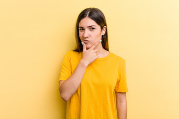 Young caucasian woman isolated on yellow background contemplating, planning a strategy, thinking about the way of a business.