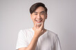 Young smiling man holding invisalign braces over white background studio, dental healthcare and Orthodontic concept..