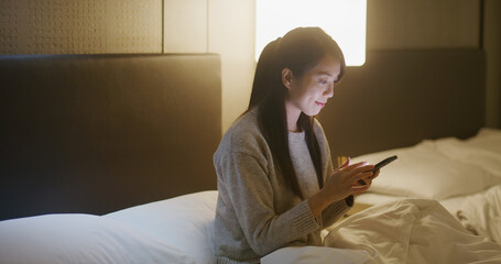 Canvas Print - Woman use smart phone at home in evening