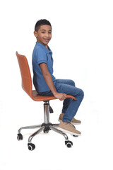 Wall Mural - sided  view of a teen sitting on a chair on white background
